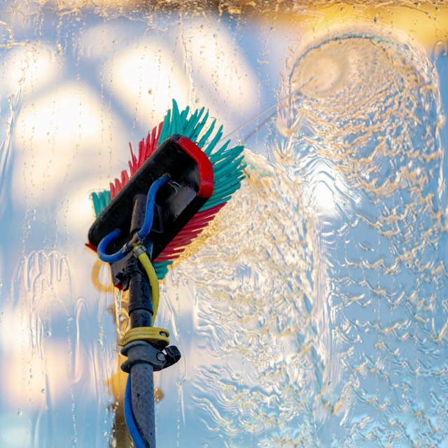 A water-fed brush cleaning glass with pure water